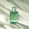 A closer-up of the orange and Woody Greenley Eau Parfum